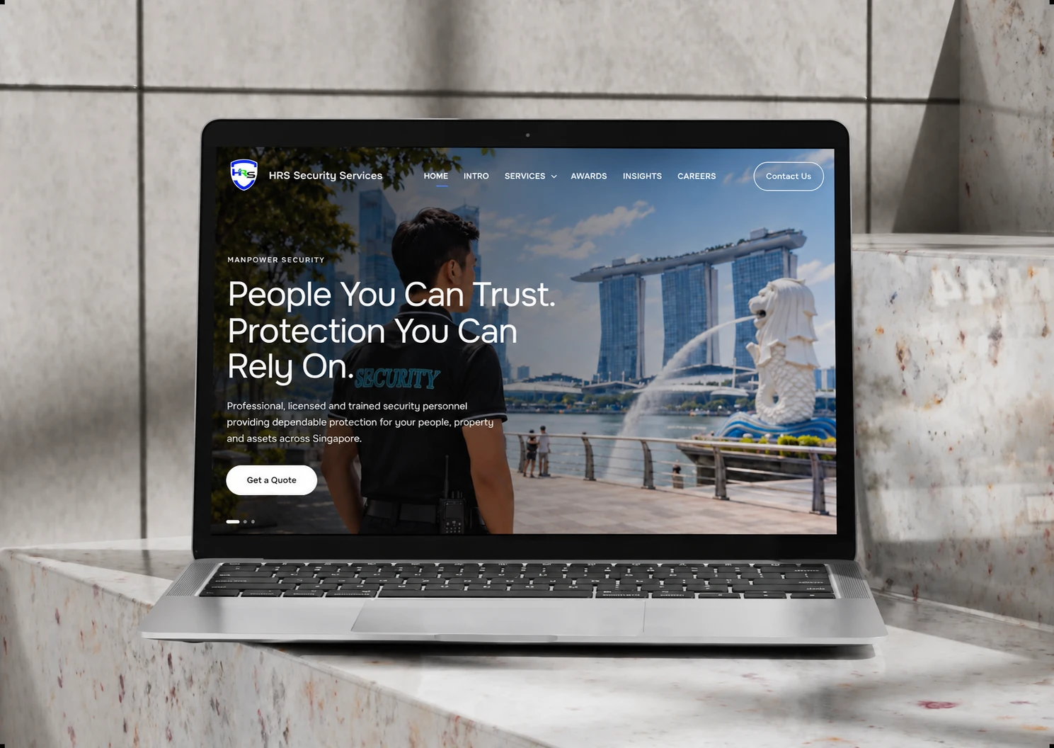 HRS Security Services website on a laptop